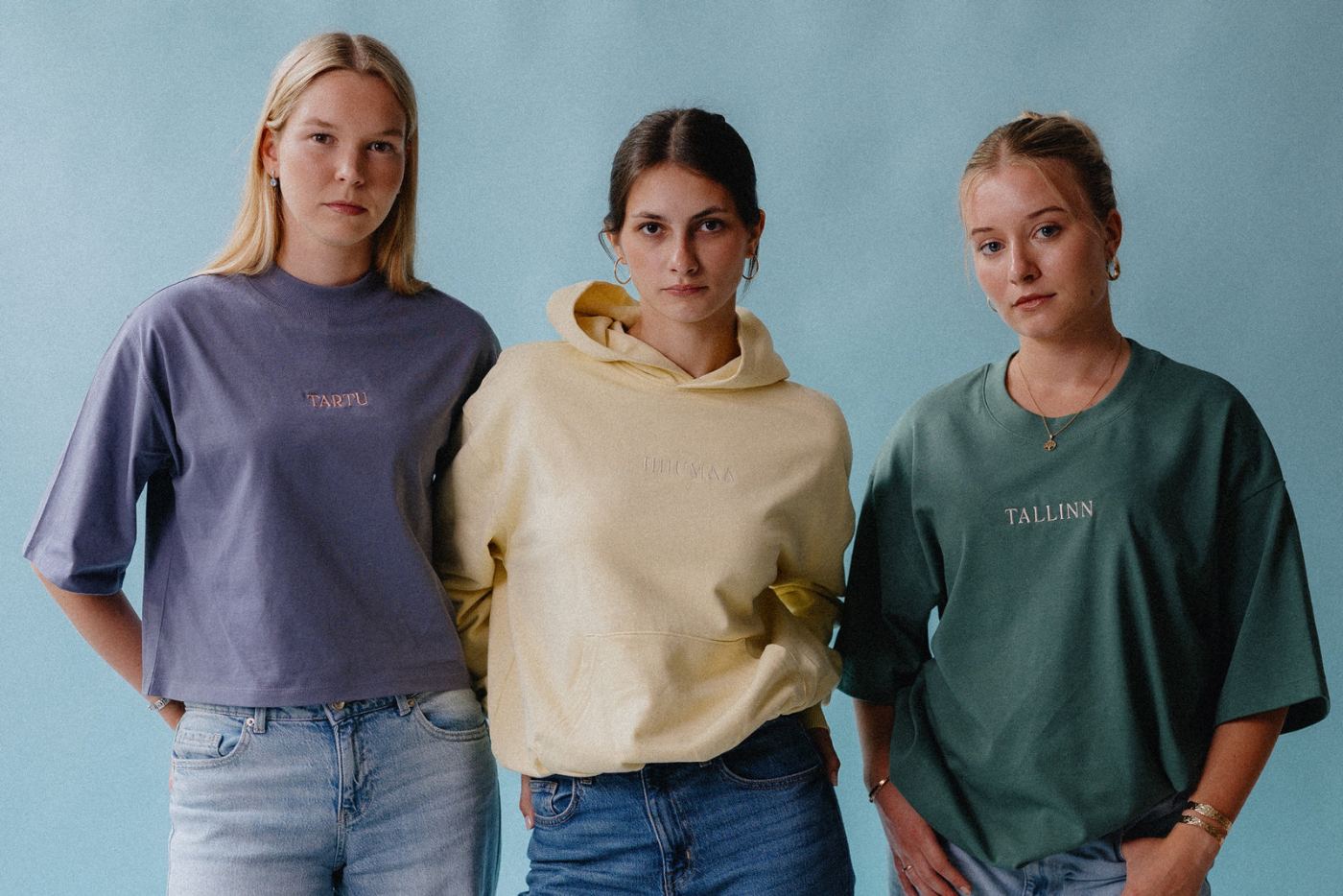 Three models in embroidered apparel