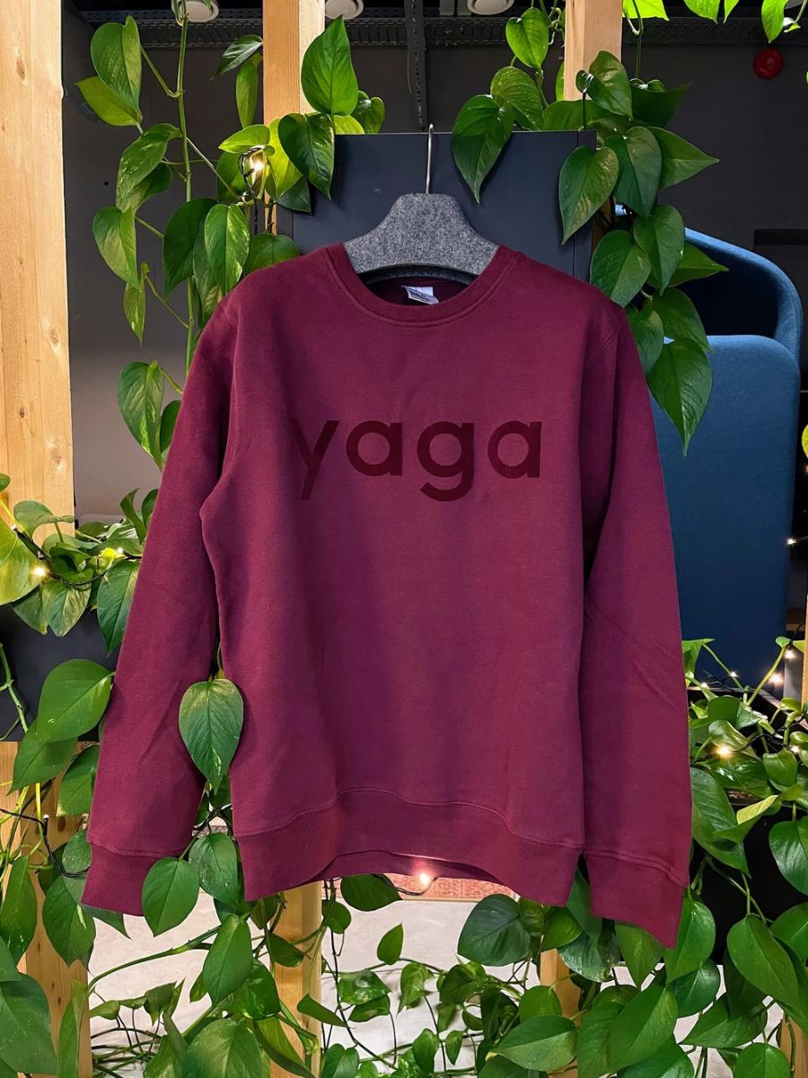 Burgundy printed sweatshirt among plants